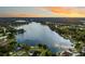 Stunning aerial view of a expansive lake surrounded by lush green forests and serene waterfront properties at 3744 E Lake Dr, Land O Lakes, FL 34639