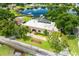 Stunning aerial view of a lakeside home with mature trees and a well-maintained lawn at 3744 E Lake Dr, Land O Lakes, FL 34639
