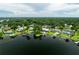 Aerial view showcasing a lake community with mature trees and private docks at 3744 E Lake Dr, Land O Lakes, FL 34639