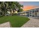 Expansive backyard with mature trees and screened-in pool offers privacy and relaxation at 3744 E Lake Dr, Land O Lakes, FL 34639