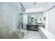 Modern bathroom with a glass-enclosed shower and double vanities, creating a spa-like retreat at 3744 E Lake Dr, Land O Lakes, FL 34639