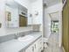 Bright bathroom featuring a white vanity with a gray countertop and a connecting doorway at 3744 E Lake Dr, Land O Lakes, FL 34639