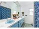 A full bathroom featuring an extended vanity, blue sinks and tiled floors at 3744 E Lake Dr, Land O Lakes, FL 34639