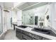 Beautiful bathroom highlighting double vanities and a glass-enclosed shower for a luxurious feel at 3744 E Lake Dr, Land O Lakes, FL 34639