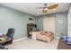This bedroom features a ceiling fan, tile floors, and a built-in bed frame with a whale toy at 3744 E Lake Dr, Land O Lakes, FL 34639