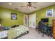 Green bedroom featuring tile flooring, a ceiling fan, and a closet at 3744 E Lake Dr, Land O Lakes, FL 34639