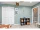 A bedroom with an anchor decoration, tile floors, and white closet doors at 3744 E Lake Dr, Land O Lakes, FL 34639