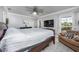 Cozy bedroom with large windows, providing lots of natural light, and features a comfortable seating area at 3744 E Lake Dr, Land O Lakes, FL 34639