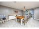 Elegant dining room with a chandelier, stylish chairs, and a wooden table set for a meal at 3744 E Lake Dr, Land O Lakes, FL 34639