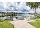 Dock with boat house, boat, rocking chairs and serene lake views at 3744 E Lake Dr, Land O Lakes, FL 34639