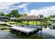 Covered boat dock with a boat lift providing easy access to the lake at 3744 E Lake Dr, Land O Lakes, FL 34639