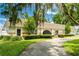 Charming single-story home with mature landscaping, inviting curb appeal, and a well-maintained front yard at 3744 E Lake Dr, Land O Lakes, FL 34639