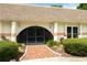 Charming home exterior with a brick walkway leading to the front door at 3744 E Lake Dr, Land O Lakes, FL 34639