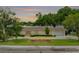Charming single story home with a brick-paved walkway and driveway, manicured lawn and flowerbed at 3744 E Lake Dr, Land O Lakes, FL 34639