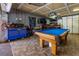 Spacious game room featuring a blue felt pool table, a miller light bar light, and a blue tool chest at 3744 E Lake Dr, Land O Lakes, FL 34639