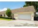 Attached two-car garage offering convenient parking and storage space on a neatly maintained lawn at 3744 E Lake Dr, Land O Lakes, FL 34639