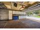 Spacious garage with ample storage cabinets and workbench at 3744 E Lake Dr, Land O Lakes, FL 34639
