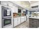 Lovely kitchen featuring white cabinets, stainless steel appliances, and a stylish farmhouse sink at 3744 E Lake Dr, Land O Lakes, FL 34639