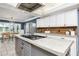 Open kitchen with a large island, stainless steel appliances, and bright dining area at 3744 E Lake Dr, Land O Lakes, FL 34639