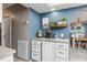 Kitchen featuring a coffee bar, white cabinets, and stylish decor at 3744 E Lake Dr, Land O Lakes, FL 34639