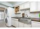 Practical laundry room with modern appliances, including stackable washer and dryer at 3744 E Lake Dr, Land O Lakes, FL 34639