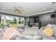 Spacious living room with large windows offering scenic views of the lake at 3744 E Lake Dr, Land O Lakes, FL 34639