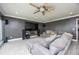 Cozy living room featuring a large TV, comfortable seating, and a ceiling fan at 3744 E Lake Dr, Land O Lakes, FL 34639