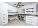 Well-lit home office features custom cabinets and an expansive desk area perfect for working from home at 3744 E Lake Dr, Land O Lakes, FL 34639