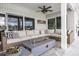 Outdoor patio features a ceiling fan, brick pillar, and cozy sectional seating at 3744 E Lake Dr, Land O Lakes, FL 34639