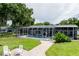 A screened pool with patio is the focal point of this beautifully landscaped backyard at 3744 E Lake Dr, Land O Lakes, FL 34639
