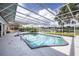 Enclosed pool area with a view of the lake and lush greenery at 3744 E Lake Dr, Land O Lakes, FL 34639