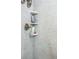 Close-up of a tiled shower showcasing built-in shelving for convenient storage at 3744 E Lake Dr, Land O Lakes, FL 34639