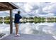 Personal casts fishing rod from private dock, serene waterfront views at 3744 E Lake Dr, Land O Lakes, FL 34639