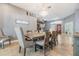 Bright dining room with a large table and chandelier, adjacent to the living room at 3904 Saddle Ridge St, Valrico, FL 33596