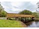 Wooden footbridge spanning a waterway in a park-like setting at 3904 Saddle Ridge St, Valrico, FL 33596