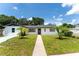 Newly renovated home with a clean white exterior and palm trees at 3214 E Dr Martin Luther King Jr Blvd, Tampa, FL 33610