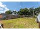 Large backyard with wooden fence and grassy area at 3214 E Dr Martin Luther King Jr Blvd, Tampa, FL 33610