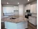 Spacious kitchen with granite countertops, white cabinets, stainless steel appliances, and an island at 18330 Cropside Trl, Lakewood Ranch, FL 34211