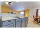 Kitchen features gray cabinets and a double sink at 11009 Maybird Ave, Weeki Wachee, FL 34613