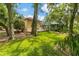 Landscaped backyard with lush greenery and a patio area at 7219 Wareham Dr, Tampa, FL 33647