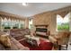 Living room featuring a stone fireplace and plush seating at 8760 Ocean Tides Cv, Parrish, FL 34219