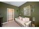 Living room with beige couch and decorative wall tapestry at 8760 Ocean Tides Cv, Parrish, FL 34219