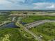 Aerial view of houses and landscape in a community at 8760 Ocean Tides Cv, Parrish, FL 34219