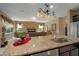 Island kitchen with granite countertops and a view of the living room at 8760 Ocean Tides Cv, Parrish, FL 34219