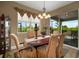 Bright dining room with table and chairs, and view of backyard at 8760 Ocean Tides Cv, Parrish, FL 34219