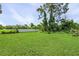 Large grassy backyard with a white vinyl fence at 455 Lenoir Nw St, Port Charlotte, FL 33948