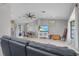 Open living space with gray sofa and view into dining area at 455 Lenoir Nw St, Port Charlotte, FL 33948