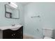 Simple bathroom with dark vanity and a large mirror at 455 Lenoir Nw St, Port Charlotte, FL 33948