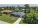 Aerial view of single story home with driveway and yard at 455 Lenoir Nw St, Port Charlotte, FL 33948