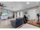 Living area with gray sofa, a home office space, and a large TV at 455 Lenoir Nw St, Port Charlotte, FL 33948